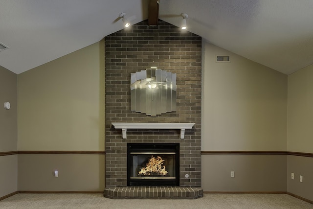 unfurnished living room with light colored carpet, a fireplace, and lofted ceiling with beams