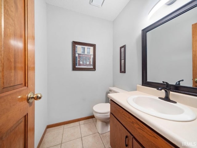 bathroom featuring vanity, toilet, and tile patterned flooring