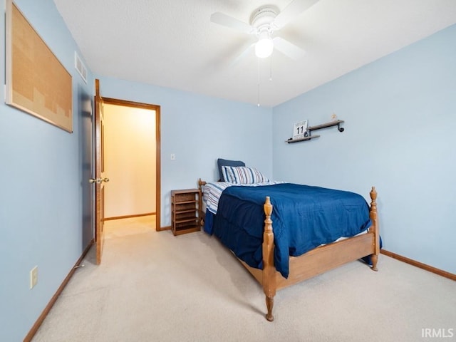 bedroom featuring light colored carpet and ceiling fan