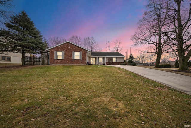 ranch-style house featuring a lawn