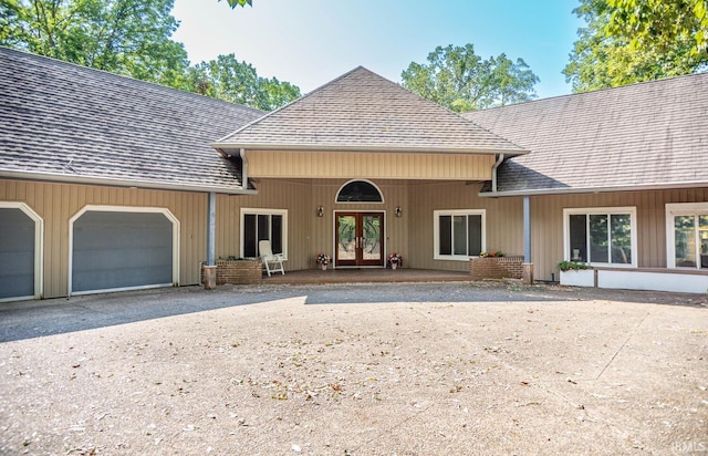 view of front of house featuring a garage and french doors