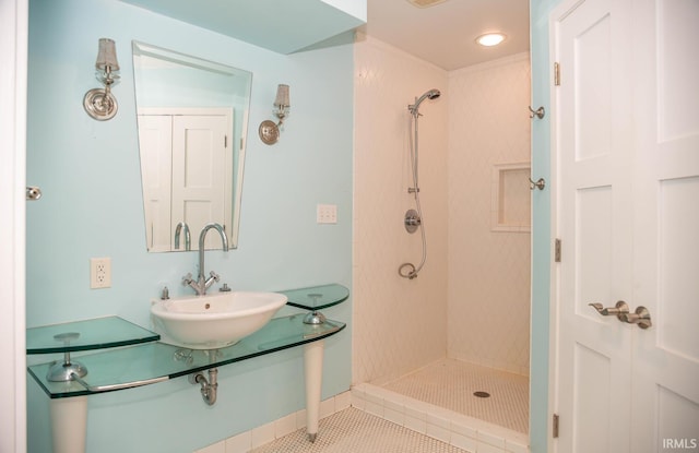 bathroom with sink, tile patterned floors, and tiled shower