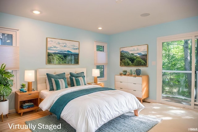 bedroom with access to exterior and light wood-type flooring