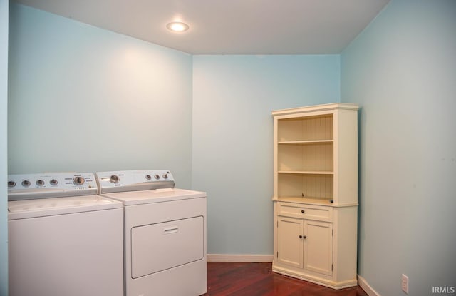 washroom with dark hardwood / wood-style floors and washer and clothes dryer