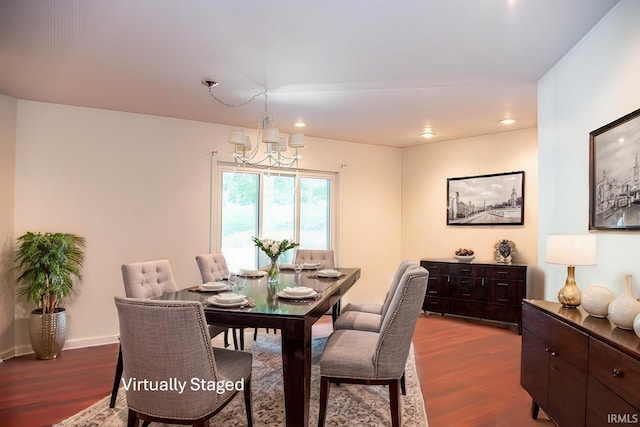 dining space featuring dark hardwood / wood-style flooring and a chandelier