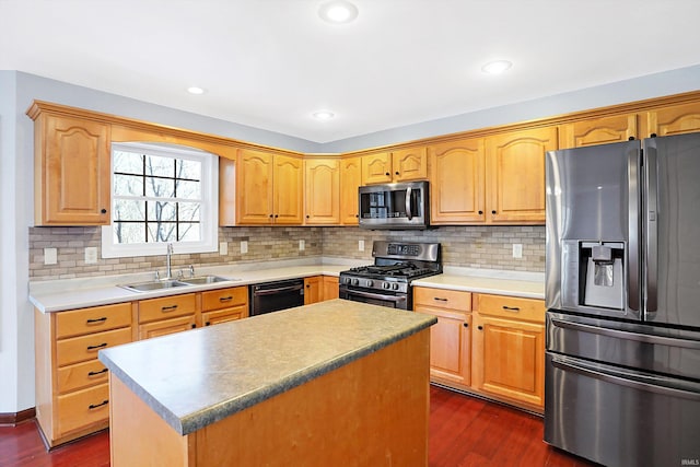 kitchen featuring sink, dark wood-type flooring, stainless steel appliances, and a kitchen island