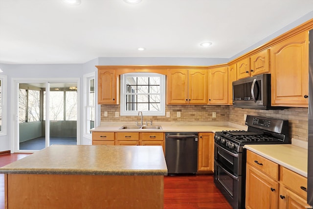 kitchen featuring sink, tasteful backsplash, double oven range, dark hardwood / wood-style flooring, and dishwasher