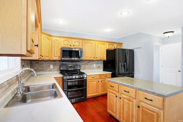 kitchen with sink, decorative backsplash, dark hardwood / wood-style floors, and appliances with stainless steel finishes