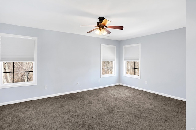 unfurnished room featuring ceiling fan and dark carpet