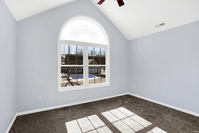 spare room featuring ceiling fan, lofted ceiling, and dark carpet