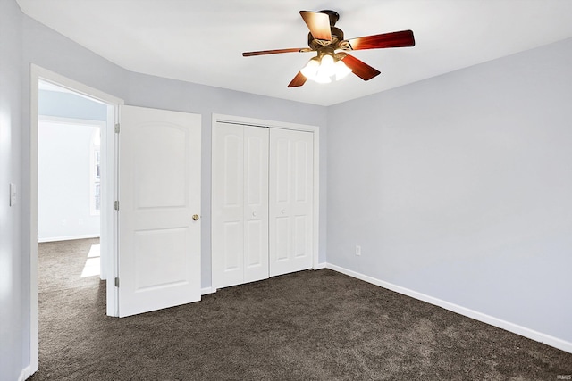 unfurnished bedroom featuring dark carpet, a closet, and ceiling fan