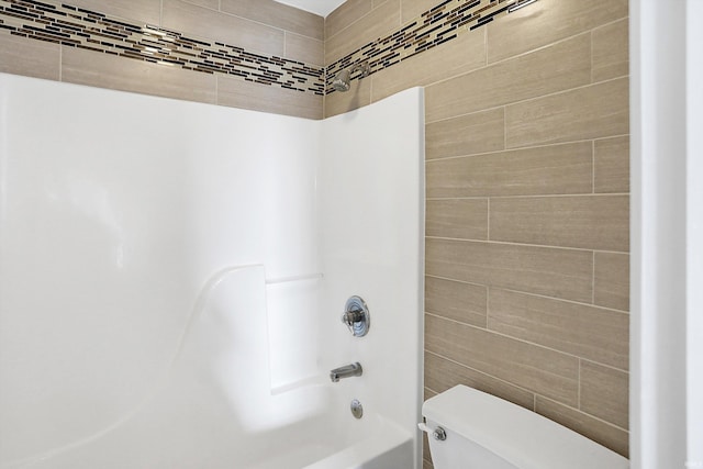 bathroom featuring toilet and bathing tub / shower combination