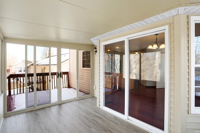 unfurnished sunroom featuring a chandelier