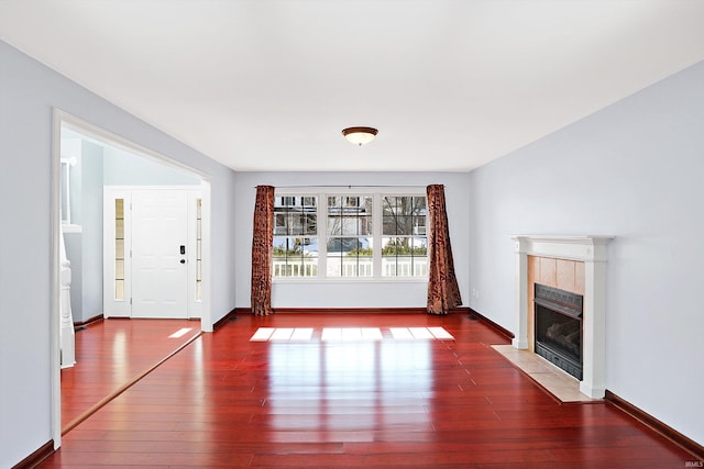 unfurnished living room featuring a fireplace and dark wood-type flooring