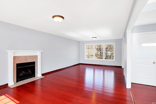 unfurnished living room with hardwood / wood-style flooring and a fireplace