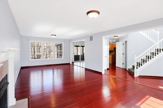 unfurnished living room with hardwood / wood-style flooring