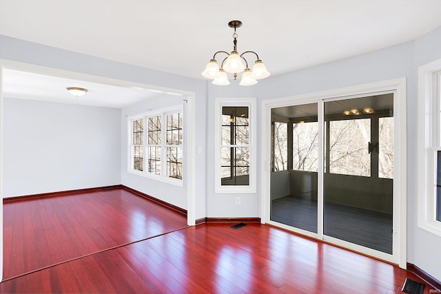 interior space with hardwood / wood-style floors and a chandelier