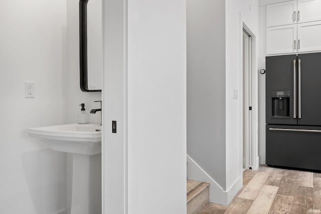 bathroom with hardwood / wood-style floors