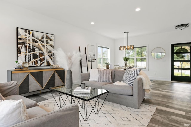 living room featuring hardwood / wood-style flooring and an inviting chandelier