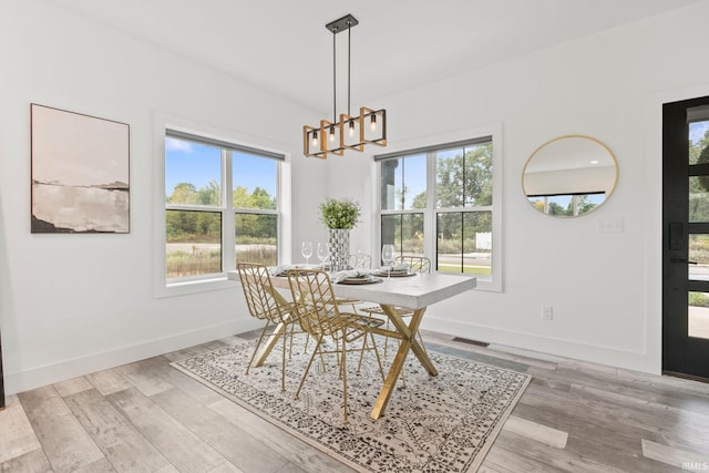 dining room featuring a chandelier and light hardwood / wood-style flooring