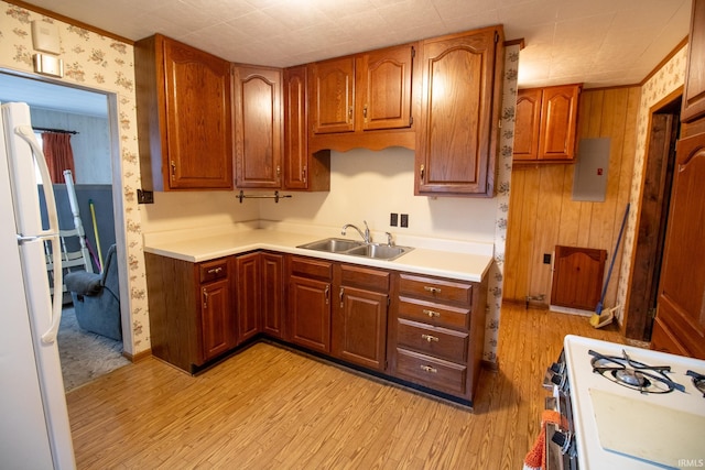 kitchen featuring sink, white appliances, and light wood-type flooring