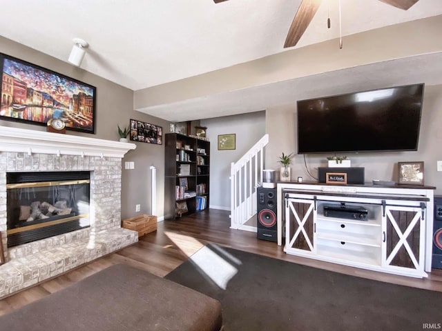 living room with dark wood-type flooring and a fireplace