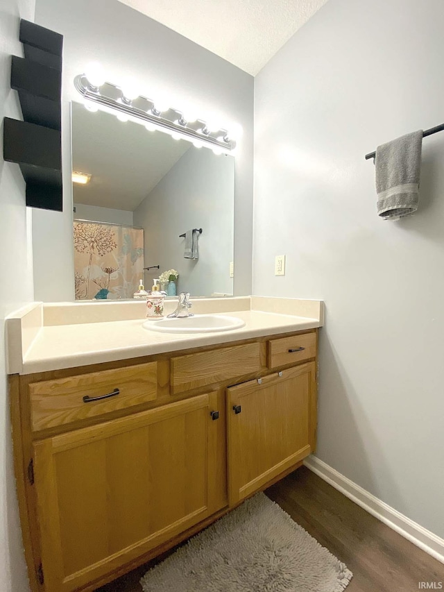 bathroom with hardwood / wood-style flooring and vanity