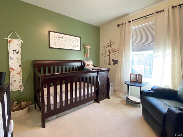 carpeted bedroom featuring a crib