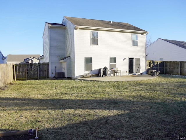 rear view of house featuring a yard, central AC unit, and a patio area