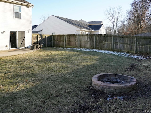 view of yard featuring a fire pit and a patio