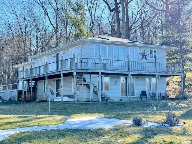 view of front of home with a deck and a front lawn