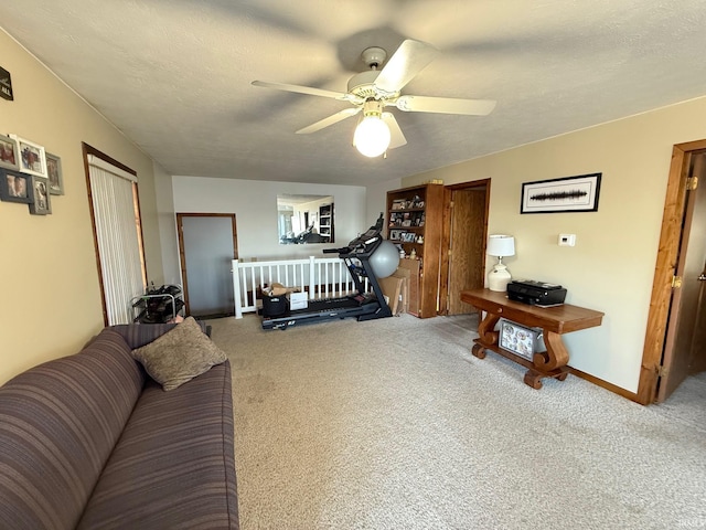 interior space featuring ceiling fan, carpet floors, and a textured ceiling