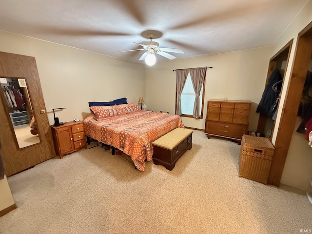 bedroom featuring light carpet and ceiling fan