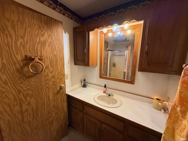 bathroom with walk in shower and vanity