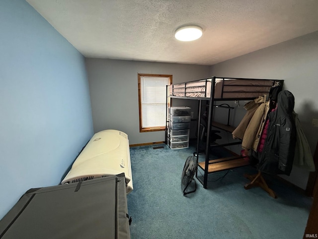 bedroom featuring carpet floors and a textured ceiling