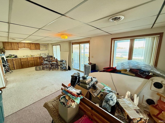 misc room with a paneled ceiling and carpet floors