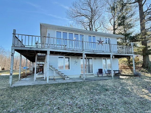 back of property with a patio, a yard, and a deck