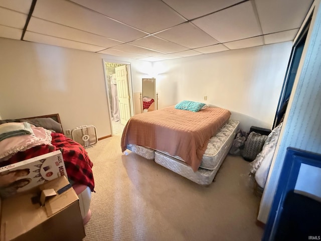 bedroom with light carpet and a drop ceiling