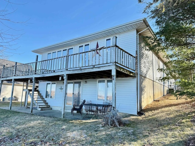 back of property with a patio and a wooden deck