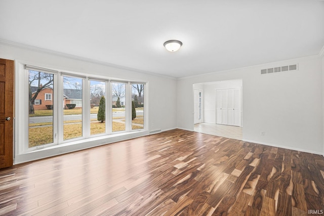 spare room featuring crown molding and hardwood / wood-style flooring