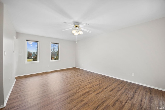 unfurnished room featuring ceiling fan and dark hardwood / wood-style flooring