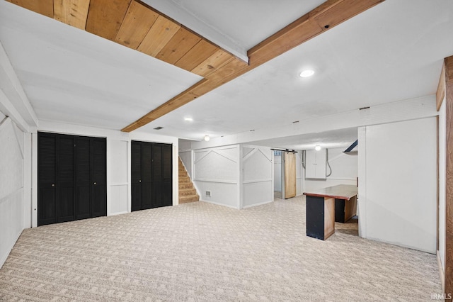 basement featuring light carpet