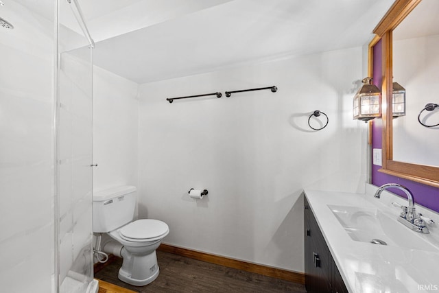 bathroom with hardwood / wood-style flooring, vanity, and toilet