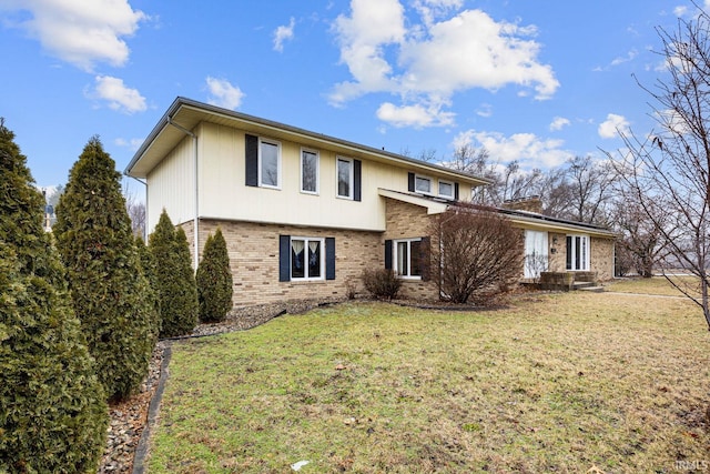 rear view of property with a lawn