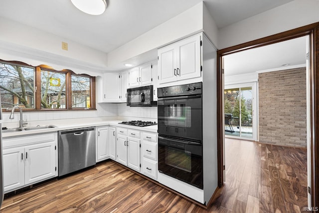 kitchen featuring sink, plenty of natural light, black appliances, and white cabinets