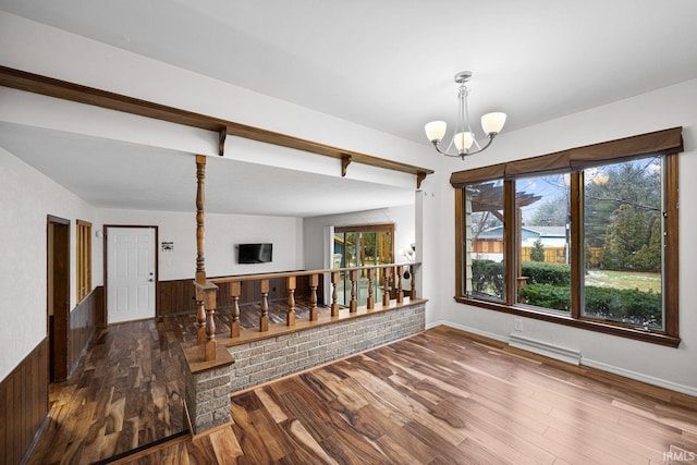 dining space featuring an inviting chandelier and dark hardwood / wood-style flooring