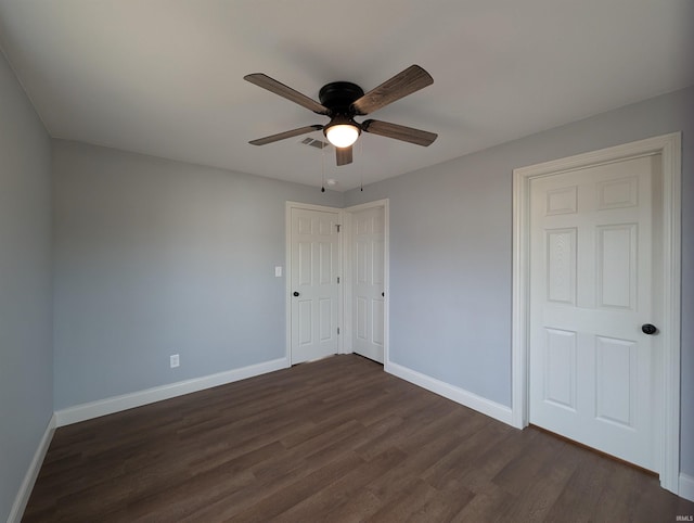 unfurnished bedroom with dark wood-type flooring and ceiling fan