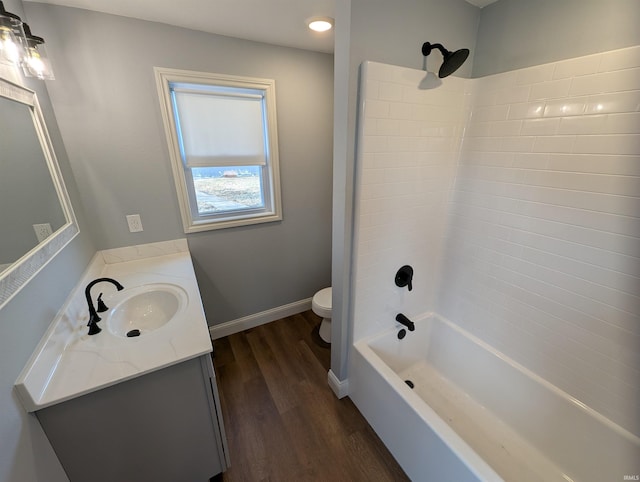 full bathroom with shower / tub combination, vanity, toilet, and hardwood / wood-style floors