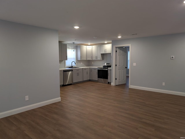 kitchen featuring dark wood-type flooring, stainless steel appliances, and sink