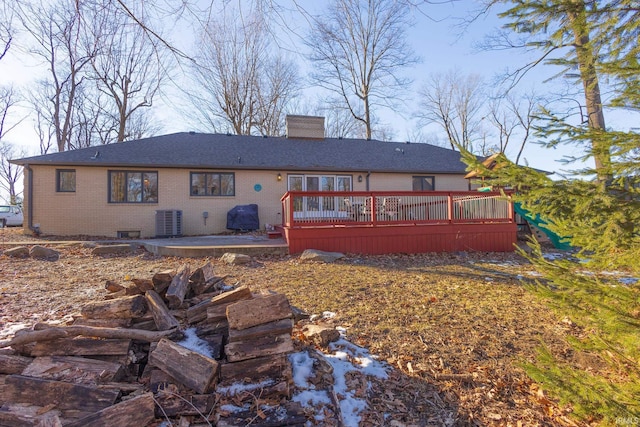 rear view of house with a patio, a wooden deck, and central air condition unit